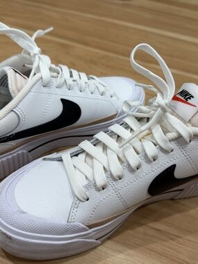 Nike White Low-Top Sneakers with Black Swoosh